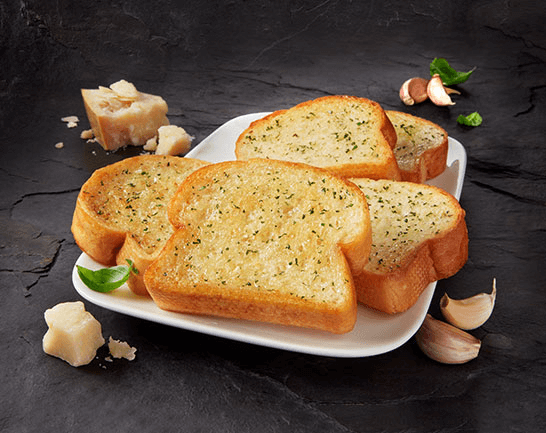 Five slices of D’Italiano Garlic toast served on a white plate and pictured on a black slate background